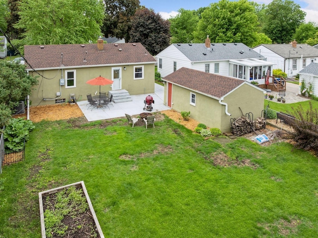 805 California Ave W, Saint Paul, MN 55117 - back of house featuring stucco siding, a patio area, and an outbuilding