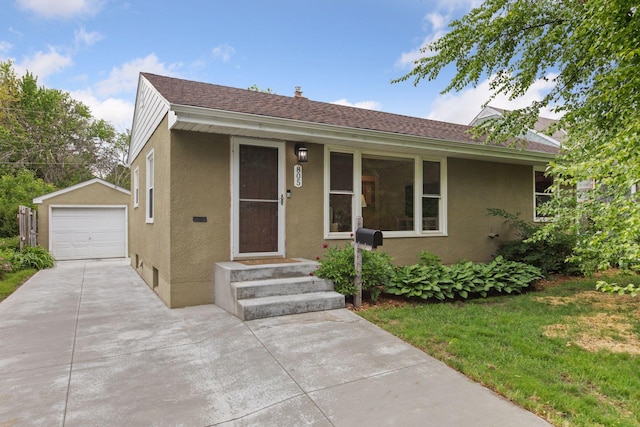 805 California Ave W, Saint Paul, MN 55117 - single story home featuring stucco siding, concrete driveway, an outbuilding, and a detached garage