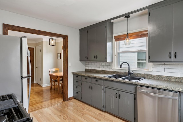 805 California Ave W, Saint Paul, MN 55117 - kitchen with dishwasher, freestanding refrigerator, a sink, gray cabinetry, and light wood-type flooring