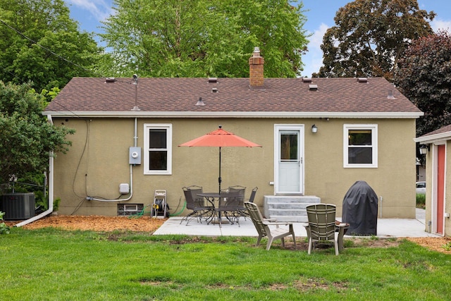 805 California Ave W, Saint Paul, MN 55117 - rear view of property featuring stucco siding, entry steps, and a yard