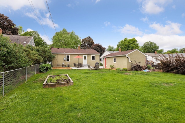 805 California Ave W, Saint Paul, MN 55117 - back of house featuring stucco siding, a patio, a chimney, and a garden