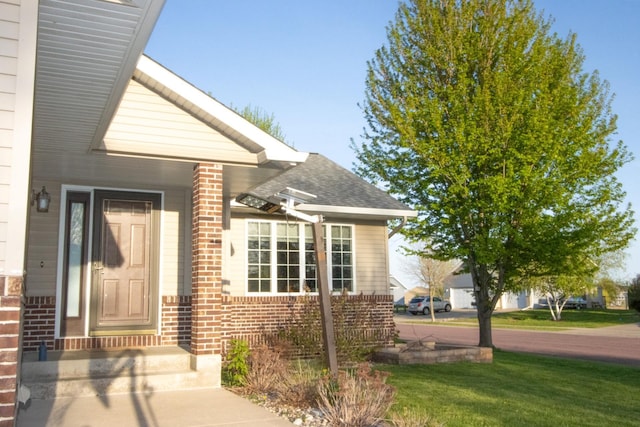 147 Waynesborough Way, Mankato, MN 56001 - entrance to property featuring brick siding, a yard, and roof with shingles