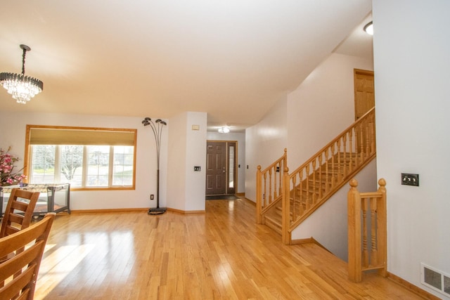 147 Waynesborough Way, Mankato, MN 56001 - foyer featuring wood finished floors, a chandelier, baseboards, and stairway