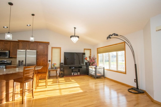 147 Waynesborough Way, Mankato, MN 56001 - living area with vaulted ceiling, light wood-style floors, baseboards, and a chandelier