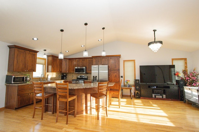 147 Waynesborough Way, Mankato, MN 56001 - kitchen with appliances with stainless steel finishes, a sink, vaulted ceiling, light wood-type flooring, and a kitchen breakfast bar