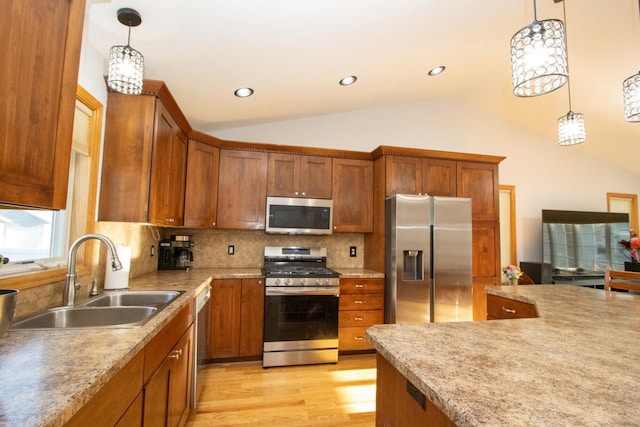 147 Waynesborough Way, Mankato, MN 56001 - kitchen featuring appliances with stainless steel finishes, a sink, lofted ceiling, brown cabinets, and decorative backsplash