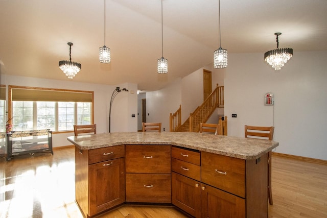 147 Waynesborough Way, Mankato, MN 56001 - kitchen featuring a chandelier, light wood finished floors, brown cabinetry, and lofted ceiling