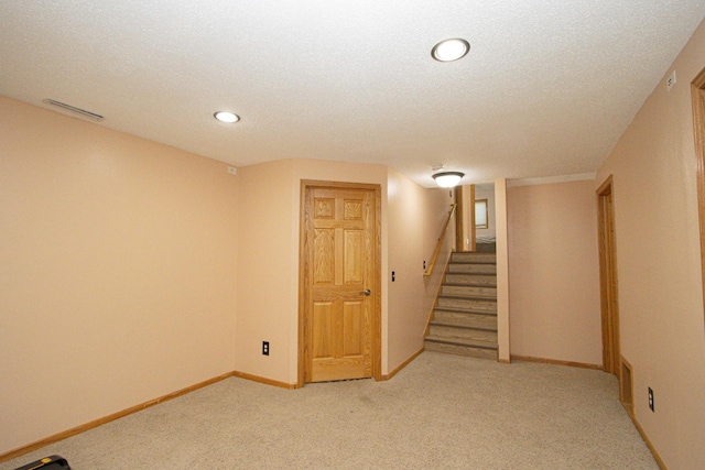 147 Waynesborough Way, Mankato, MN 56001 - finished below grade area with light carpet, stairs, recessed lighting, baseboards, and a textured ceiling