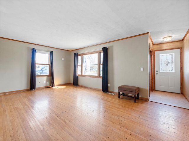 116 California Ave, Morris, MN 56267 - unfurnished living room featuring crown molding, light wood-style flooring, and baseboards