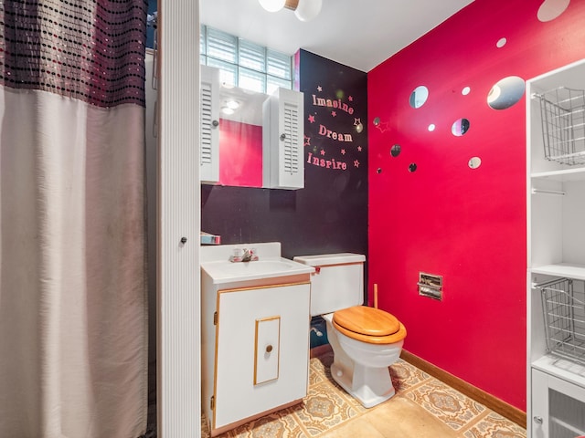 116 California Ave, Morris, MN 56267 - bathroom featuring toilet, vanity, tile patterned flooring, and baseboards
