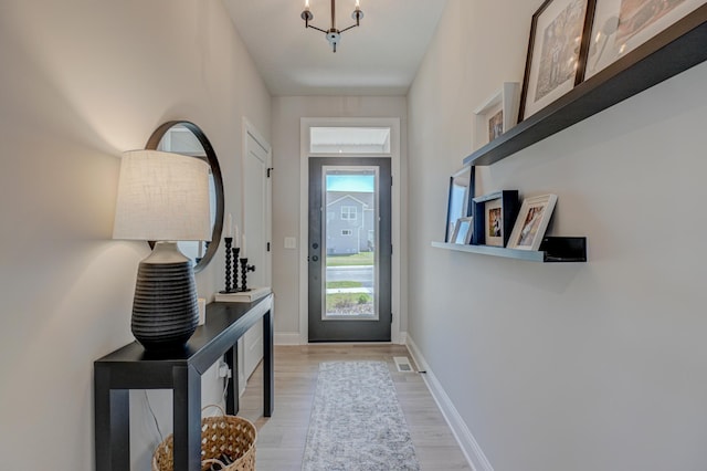 entryway featuring light wood-style floors and baseboards