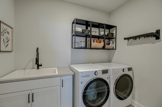 laundry room featuring cabinet space, independent washer and dryer, and baseboards