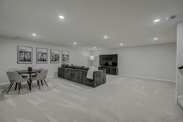living room featuring light carpet, recessed lighting, and baseboards