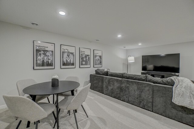 living area featuring light colored carpet and recessed lighting