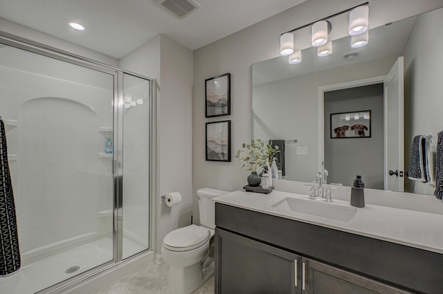 bathroom featuring a stall shower, toilet, vanity, and recessed lighting