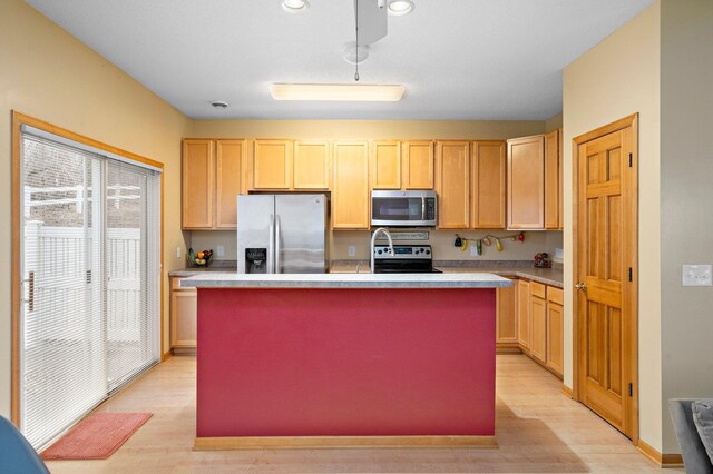 16322 70th Ave N Unit 304, Maple Grove, MN 55311 - kitchen featuring stainless steel appliances, light wood-type flooring, a kitchen island with sink, light countertops, and light brown cabinetry