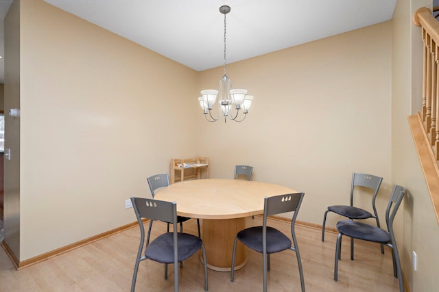 16322 70th Ave N Unit 304, Maple Grove, MN 55311 - dining space with light wood-style floors, a chandelier, and baseboards