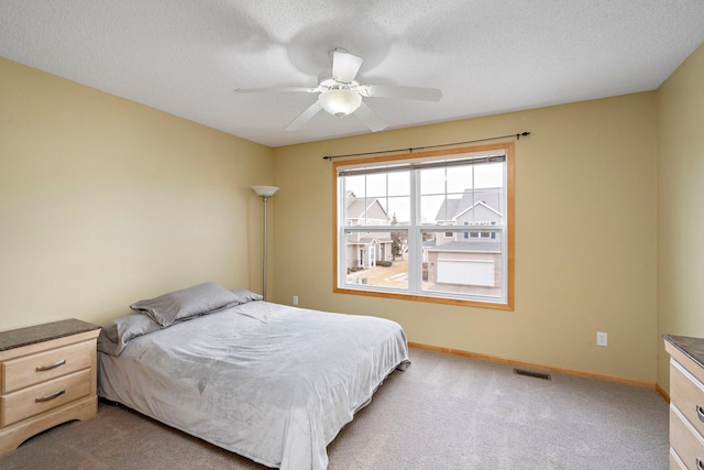 16322 70th Ave N Unit 304, Maple Grove, MN 55311 - bedroom featuring light colored carpet, baseboards, a textured ceiling, and a ceiling fan