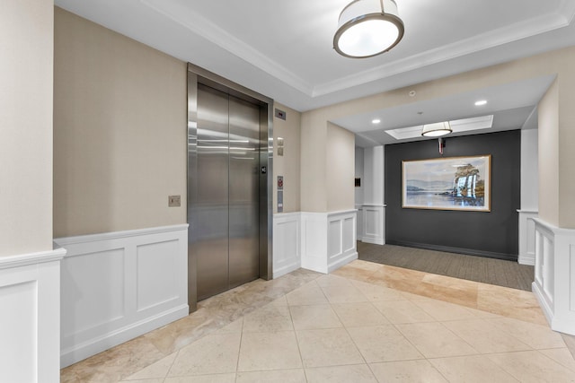 1320 Riverside Ln Unit 112, Mendota Heights, MN 55118 - hallway featuring elevator, a raised ceiling, light tile patterned floors, a decorative wall, and wainscoting