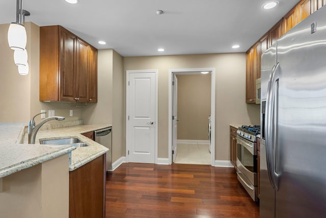 1320 Riverside Ln Unit 112, Mendota Heights, MN 55118 - kitchen with appliances with stainless steel finishes, light stone counters, recessed lighting, dark wood finished floors, and decorative light fixtures