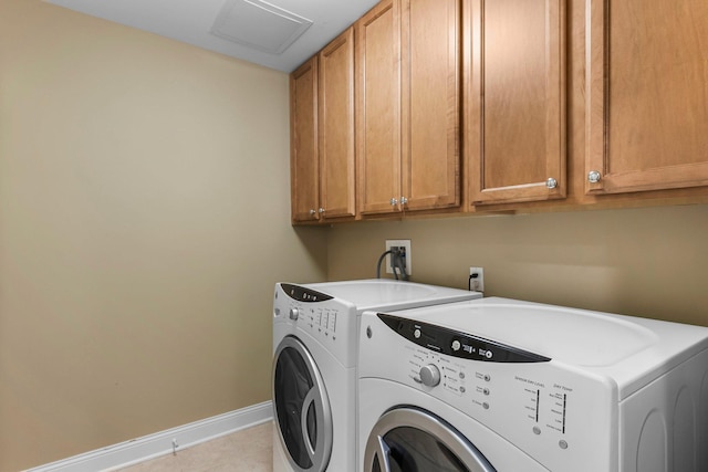 1320 Riverside Ln Unit 112, Mendota Heights, MN 55118 - washroom featuring cabinet space, washer and dryer, and tile patterned floors