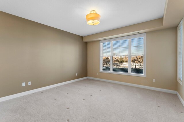 1320 Riverside Ln Unit 112, Mendota Heights, MN 55118 - spare room with baseboards and light colored carpet