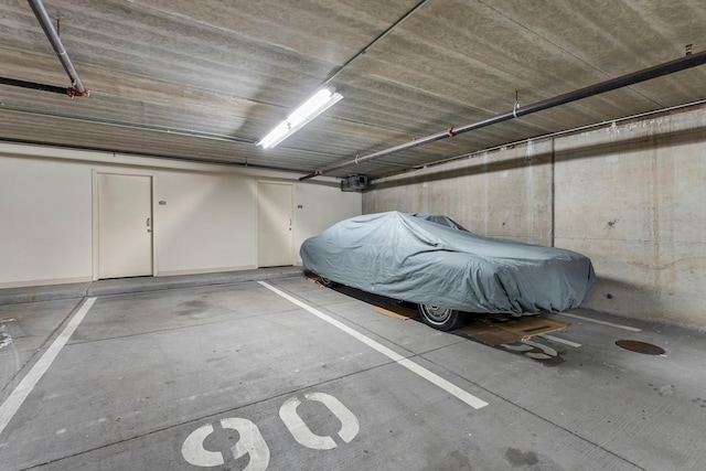1320 Riverside Ln Unit 112, Mendota Heights, MN 55118 - parking deck featuring a garage door opener