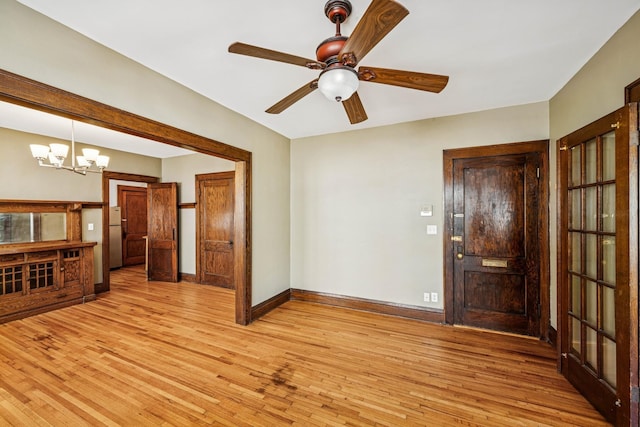 3441 Portland Ave Unit 1, Minneapolis, MN 55407 - unfurnished room with light wood finished floors, a chandelier, baseboards, and a ceiling fan