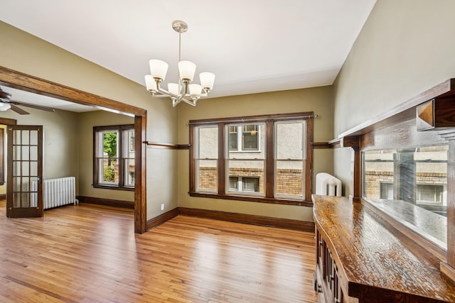 3441 Portland Ave Unit 1, Minneapolis, MN 55407 - unfurnished dining area with radiator heating unit, baseboards, and light wood-style floors