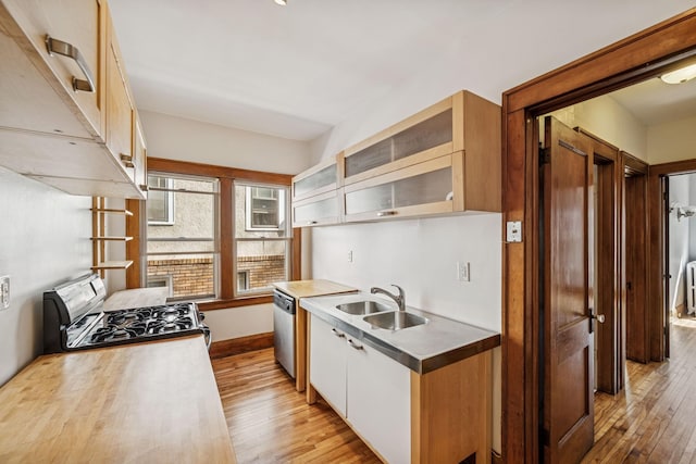 3441 Portland Ave Unit 1, Minneapolis, MN 55407 - kitchen with a sink, range with gas cooktop, light wood-style flooring, stainless steel dishwasher, and glass insert cabinets