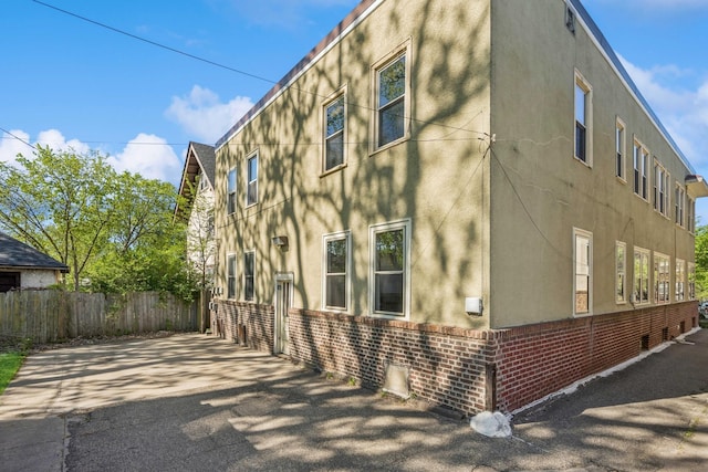 3441 Portland Ave Unit 1, Minneapolis, MN 55407 - view of home's exterior with stucco siding and brick siding