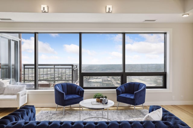 living area with wood finished floors and baseboards
