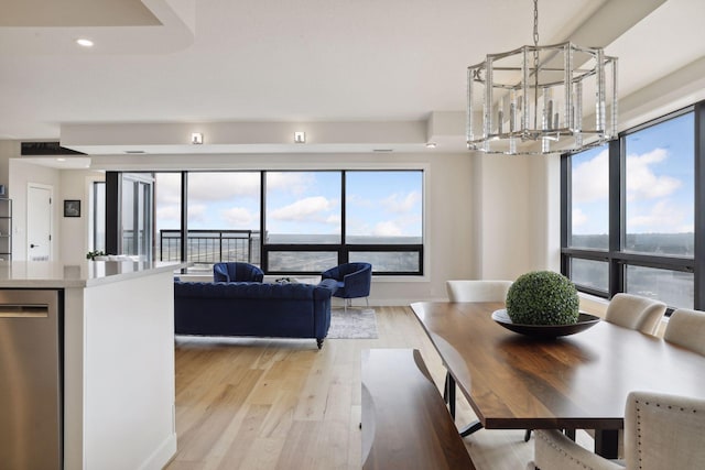 dining space with a chandelier, light wood-style floors, and recessed lighting
