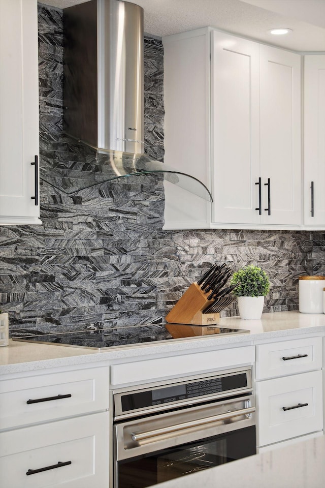 bar area with stainless steel oven and tasteful backsplash
