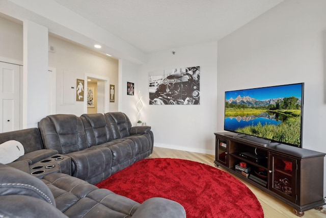 living area with wood finished floors and recessed lighting