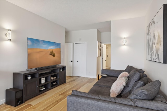living room featuring light wood-style floors and baseboards