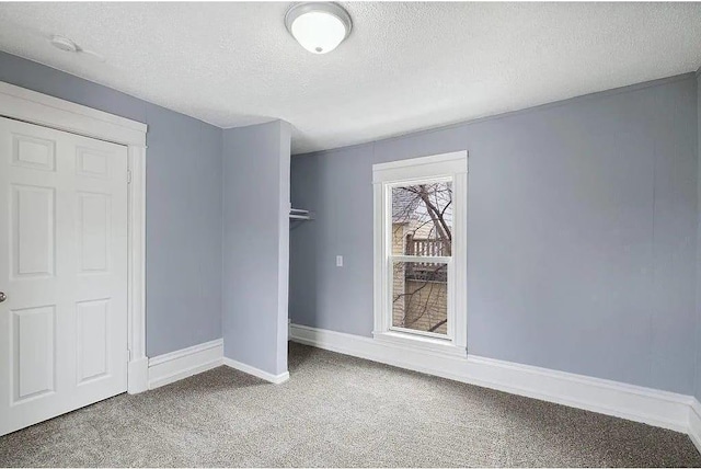 2723 Dupont Ave N, Minneapolis, MN 55411 - unfurnished bedroom with carpet floors, a textured ceiling, baseboards, and a closet