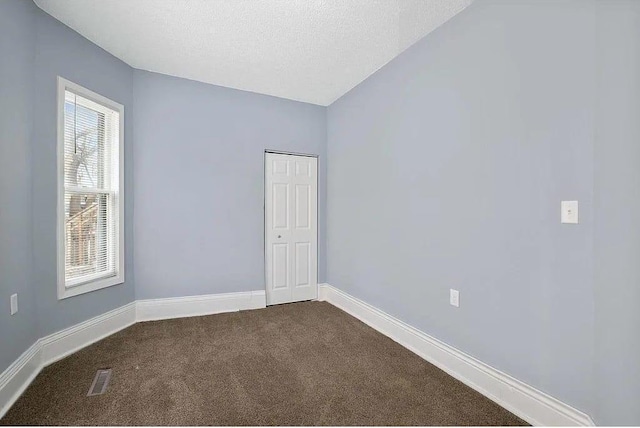 2723 Dupont Ave N, Minneapolis, MN 55411 - spare room featuring dark colored carpet and baseboards