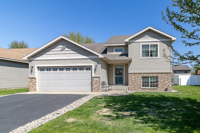 105 Doral Dr, Mankato, MN 56001 - craftsman-style house with brick siding, asphalt driveway, and a garage