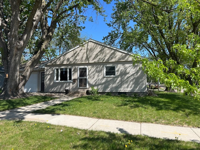 view of front facade with a garage and a front lawn
