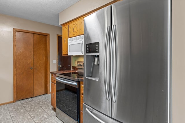 8251 158th Ln NW, Ramsey, MN 55303 - kitchen featuring stainless steel appliances, dark countertops, a textured ceiling, and light tile patterned flooring