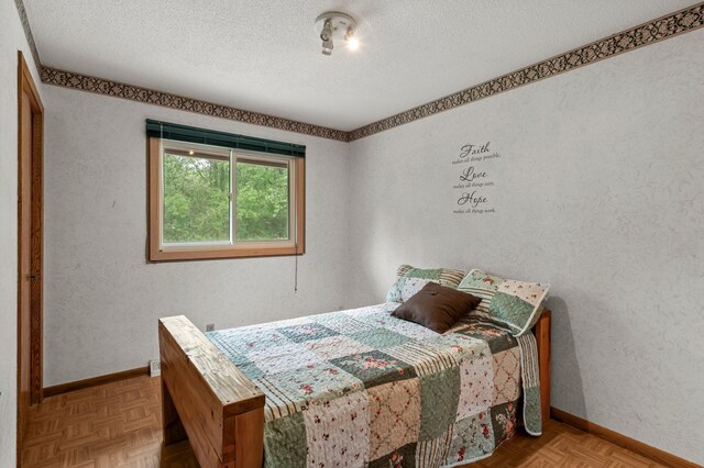 8251 158th Ln NW, Ramsey, MN 55303 - bedroom with a textured ceiling and baseboards