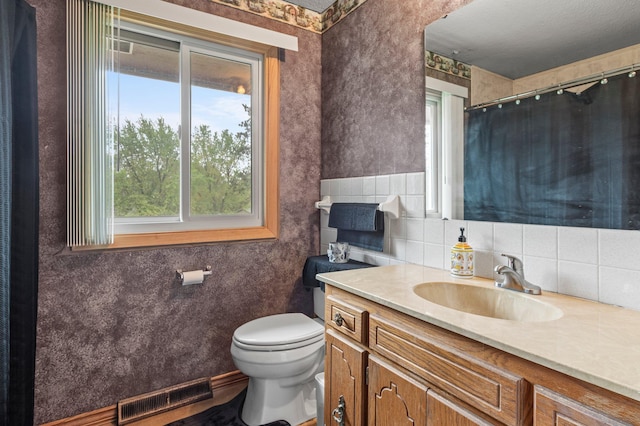 8251 158th Ln NW, Ramsey, MN 55303 - bathroom featuring plenty of natural light, toilet, vanity, and a shower with shower curtain