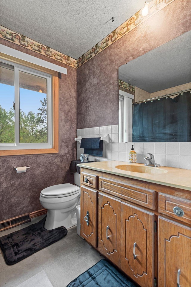 8251 158th Ln NW, Ramsey, MN 55303 - full bathroom with toilet, vanity, and a textured ceiling