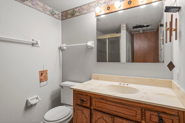 8251 158th Ln NW, Ramsey, MN 55303 - bathroom featuring a textured ceiling, a stall shower, vanity, and toilet
