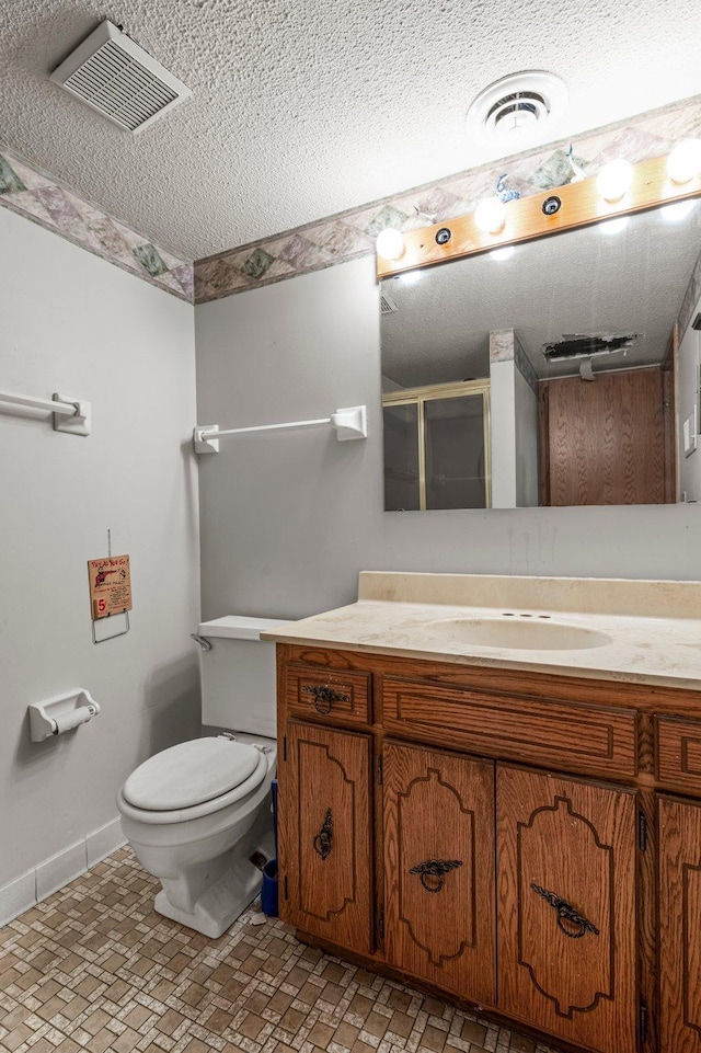8251 158th Ln NW, Ramsey, MN 55303 - bathroom with a textured ceiling, a shower stall, baseboards, vanity, and toilet