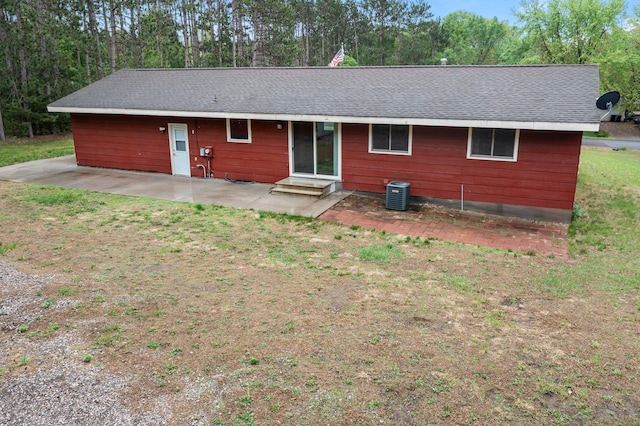 8251 158th Ln NW, Ramsey, MN 55303 - rear view of house with cooling unit, a patio, entry steps, a shingled roof, and a lawn