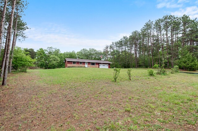 8251 158th Ln NW, Ramsey, MN 55303 - view of grassy yard with a wooded view