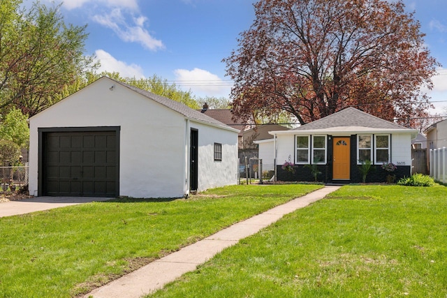 bungalow-style house with a garage, concrete driveway, an outbuilding, and stucco siding