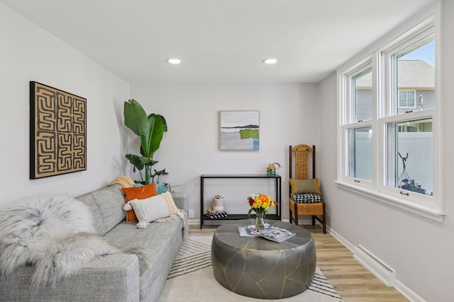 living area with light wood finished floors, baseboards, and recessed lighting